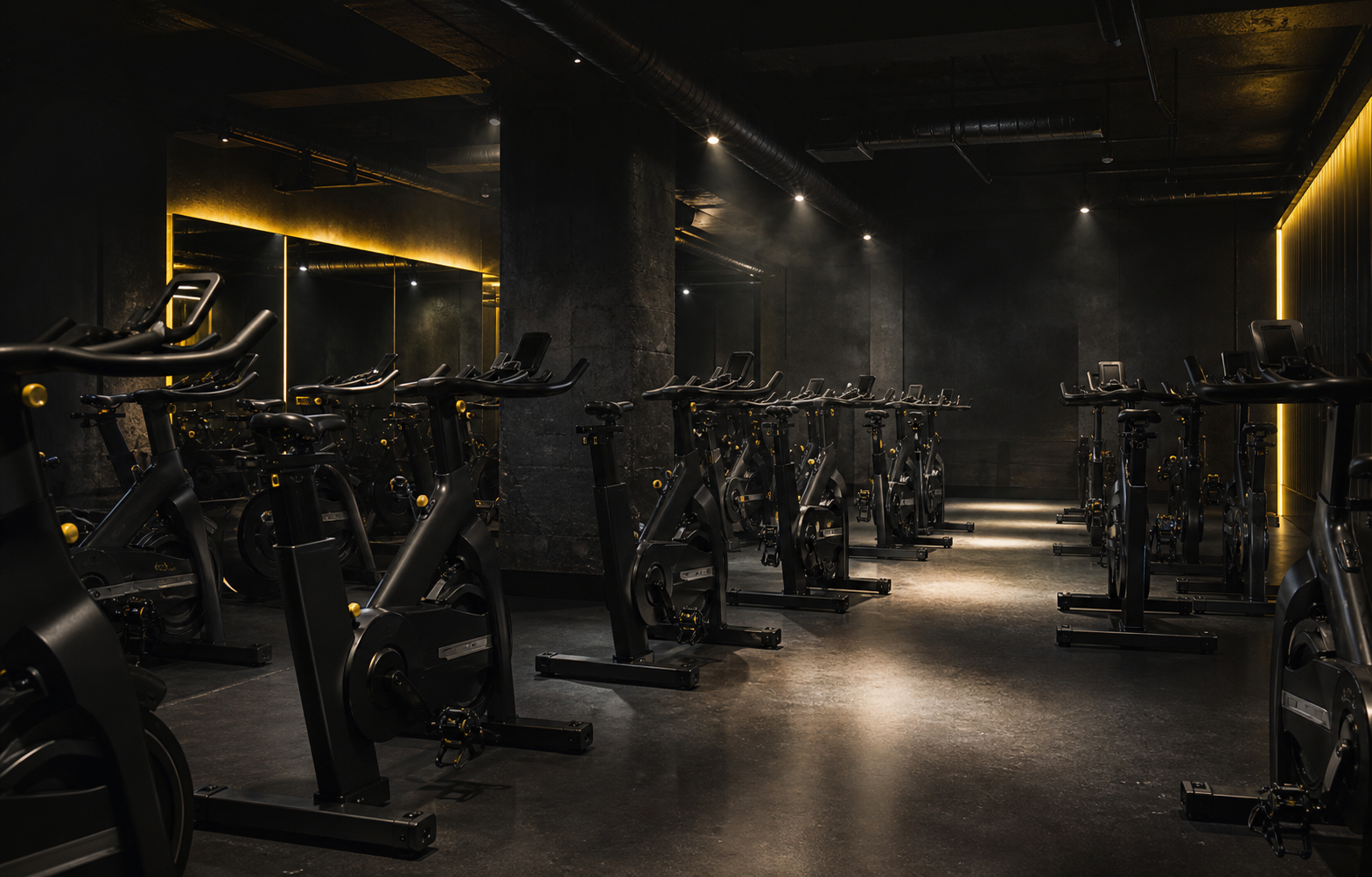 Rows of bikes inside a low-lit CycleBox studio